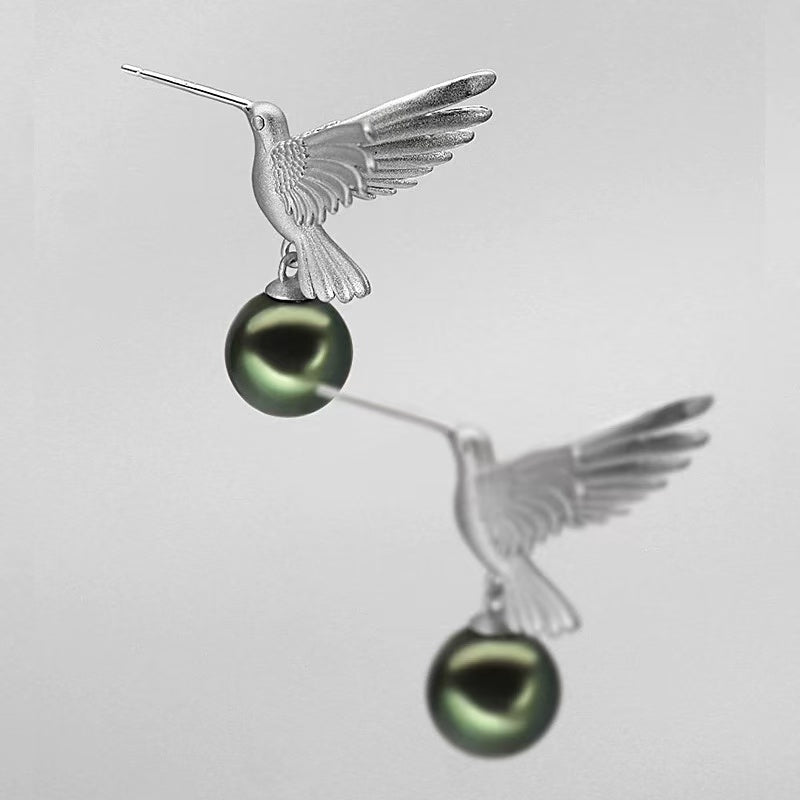 “A mist on the sea where the hummingbirds fly” Handmade gold and silver carved hummingbird pearl earrings