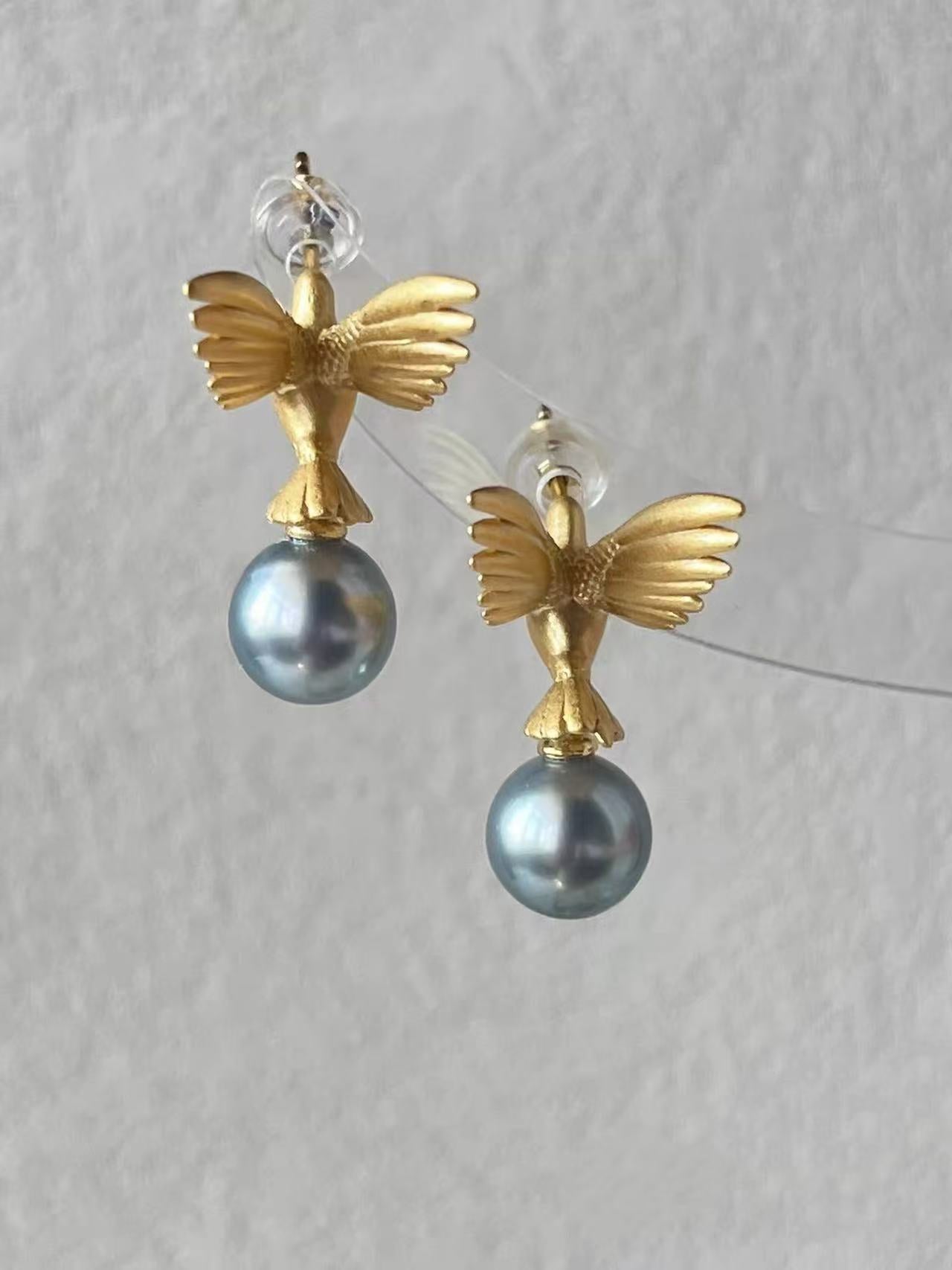 “A mist on the sea where the hummingbirds fly” Handmade gold and silver carved hummingbird pearl earrings