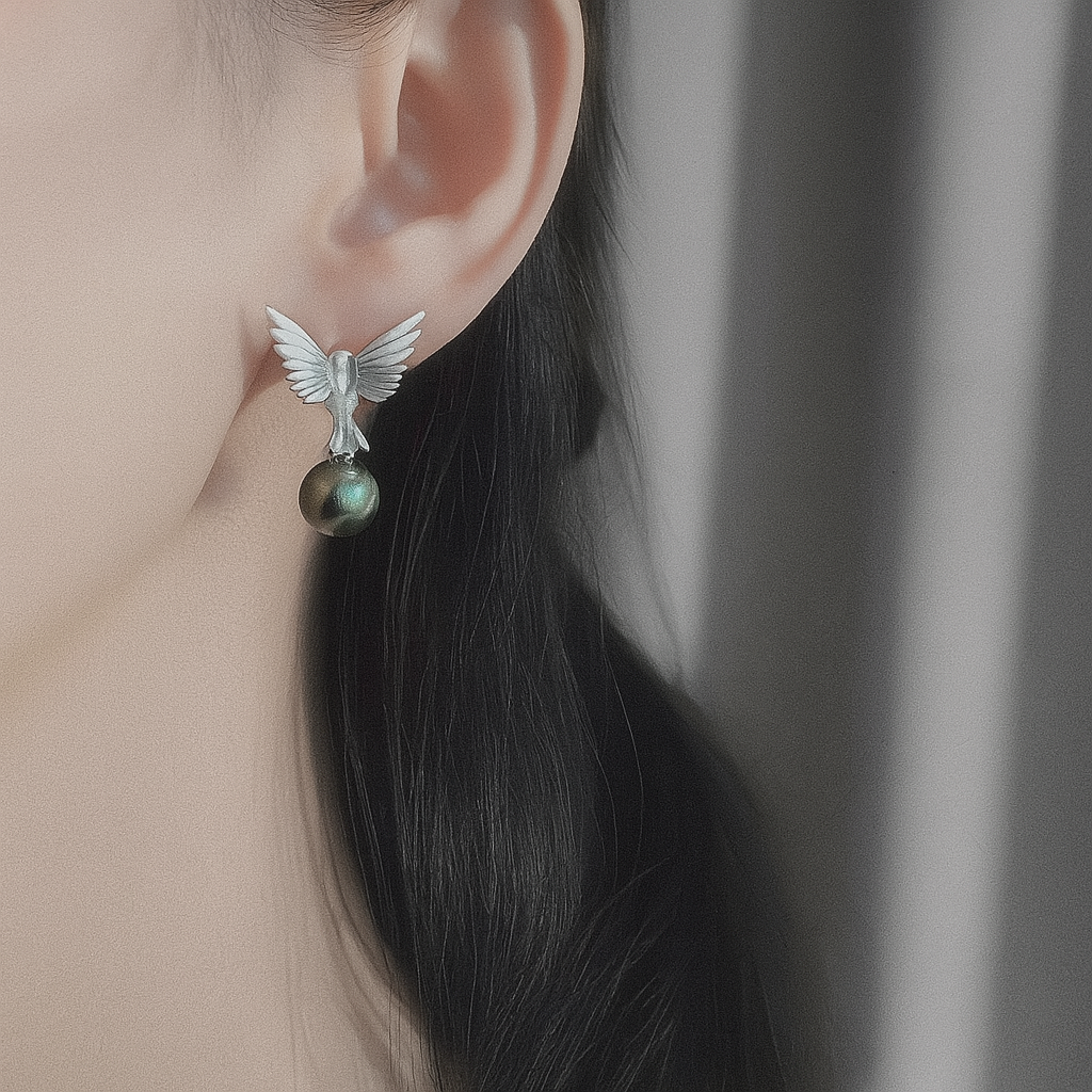 “A mist on the sea where the hummingbirds fly” Handmade gold and silver carved hummingbird pearl earrings