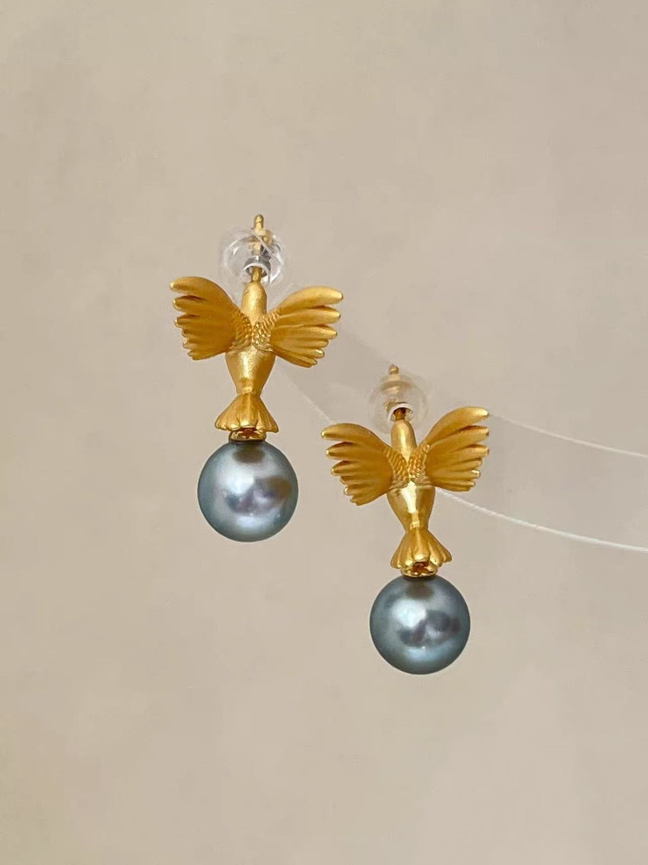 “A mist on the sea where the hummingbirds fly” Handmade gold and silver carved hummingbird pearl earrings