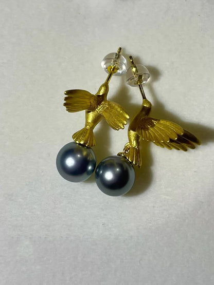 “A mist on the sea where the hummingbirds fly” Handmade gold and silver carved hummingbird pearl earrings